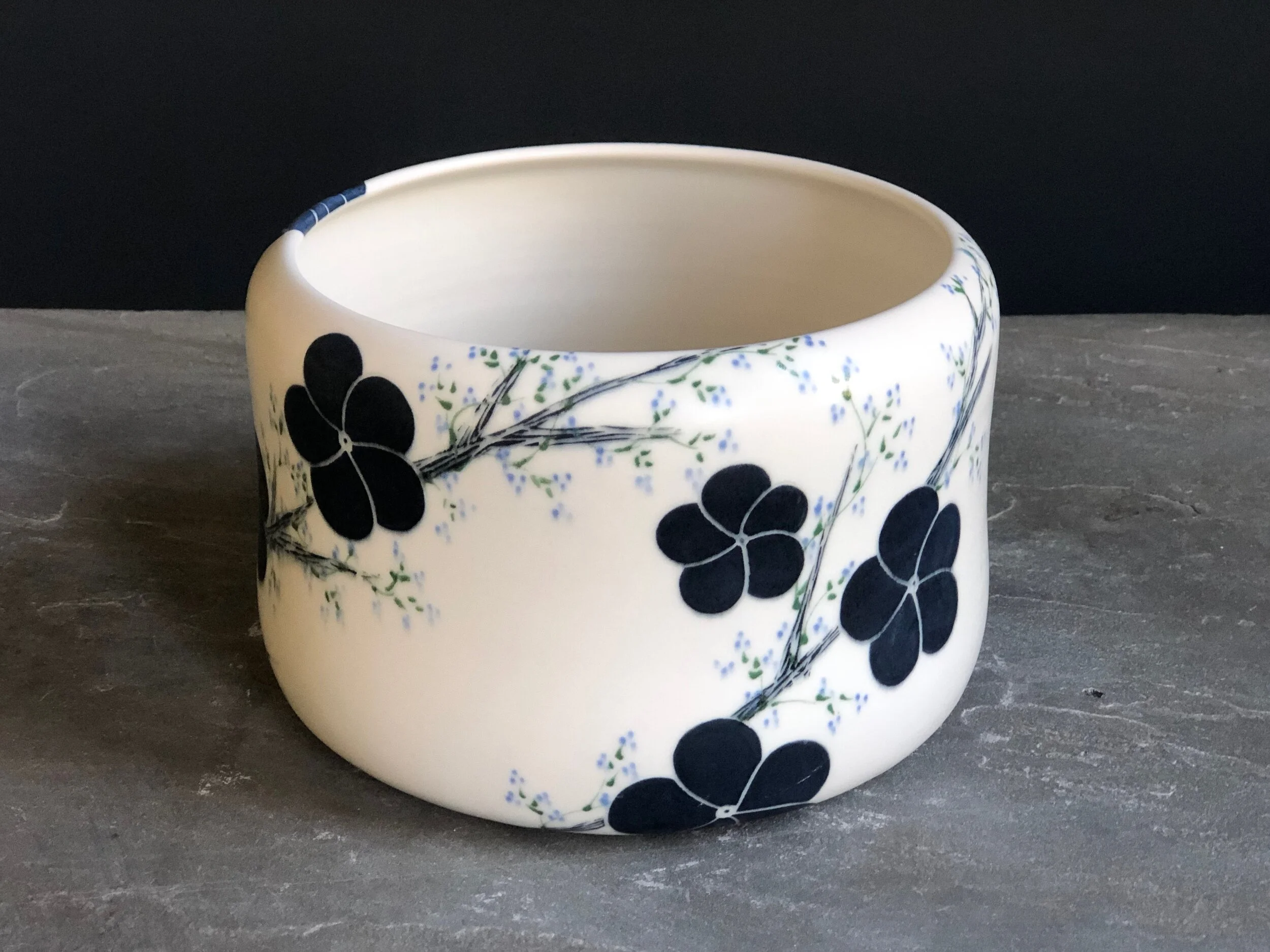 Vase With Black Blossoms, Green Branches and Blue Flowers