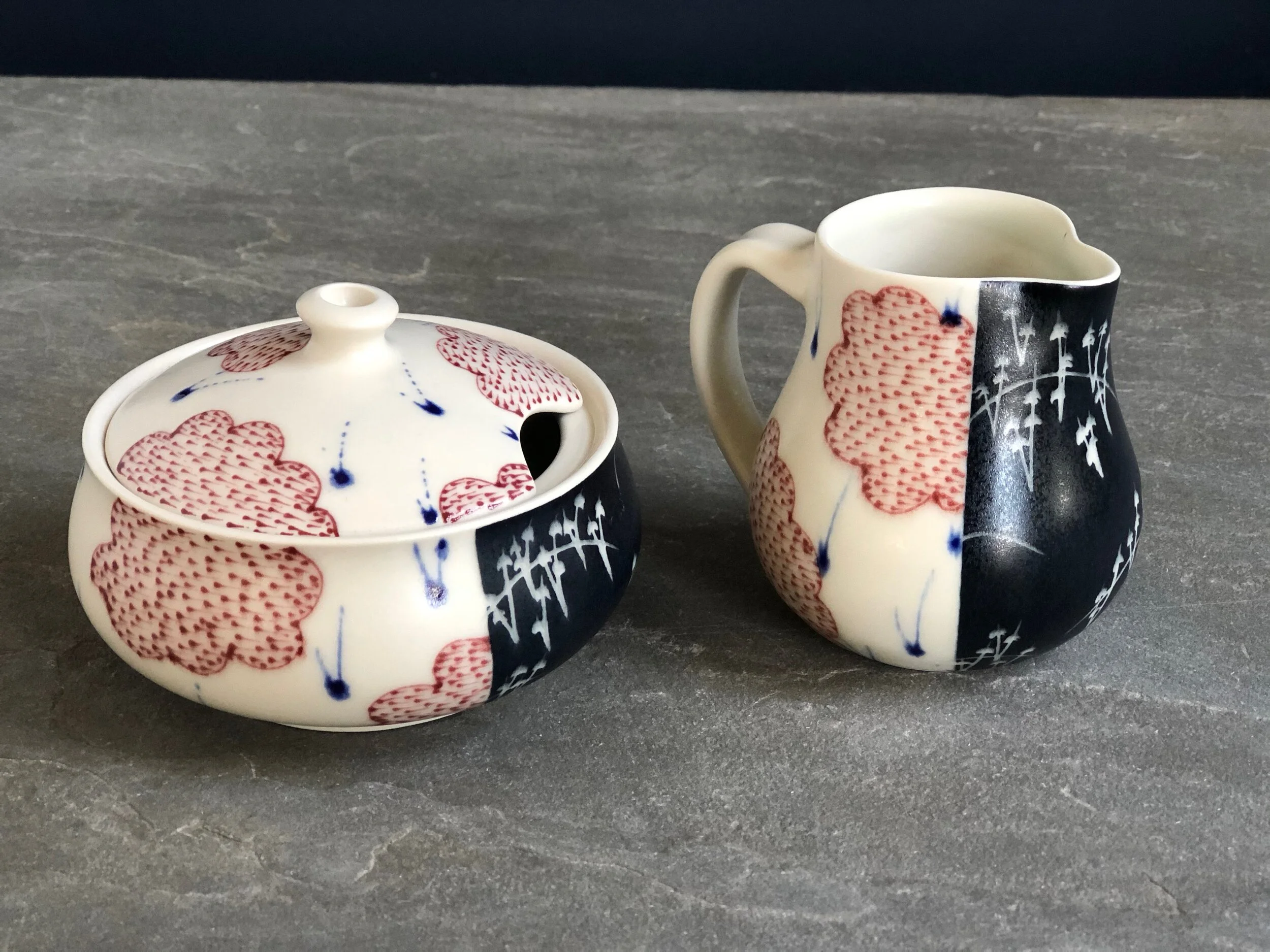 Creamer and Sugar With Red Clouds and Black Sgraffito 