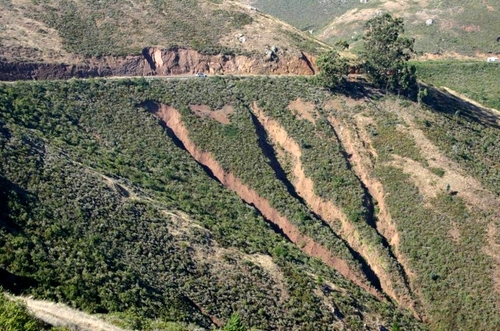 Culverts draining roads may cause massive gully formation if there is no armoring or system of deflection. Gullies on hill slopes and meadows also cause a secondary problem, they drop the water table.
