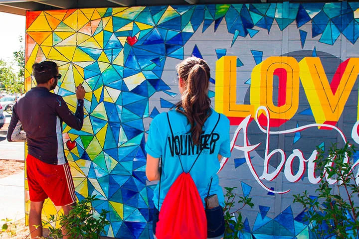Love Abounds Mural on the wall at Dutch Bros Coffee at Lamar Station Plaza by Pepe Gaka