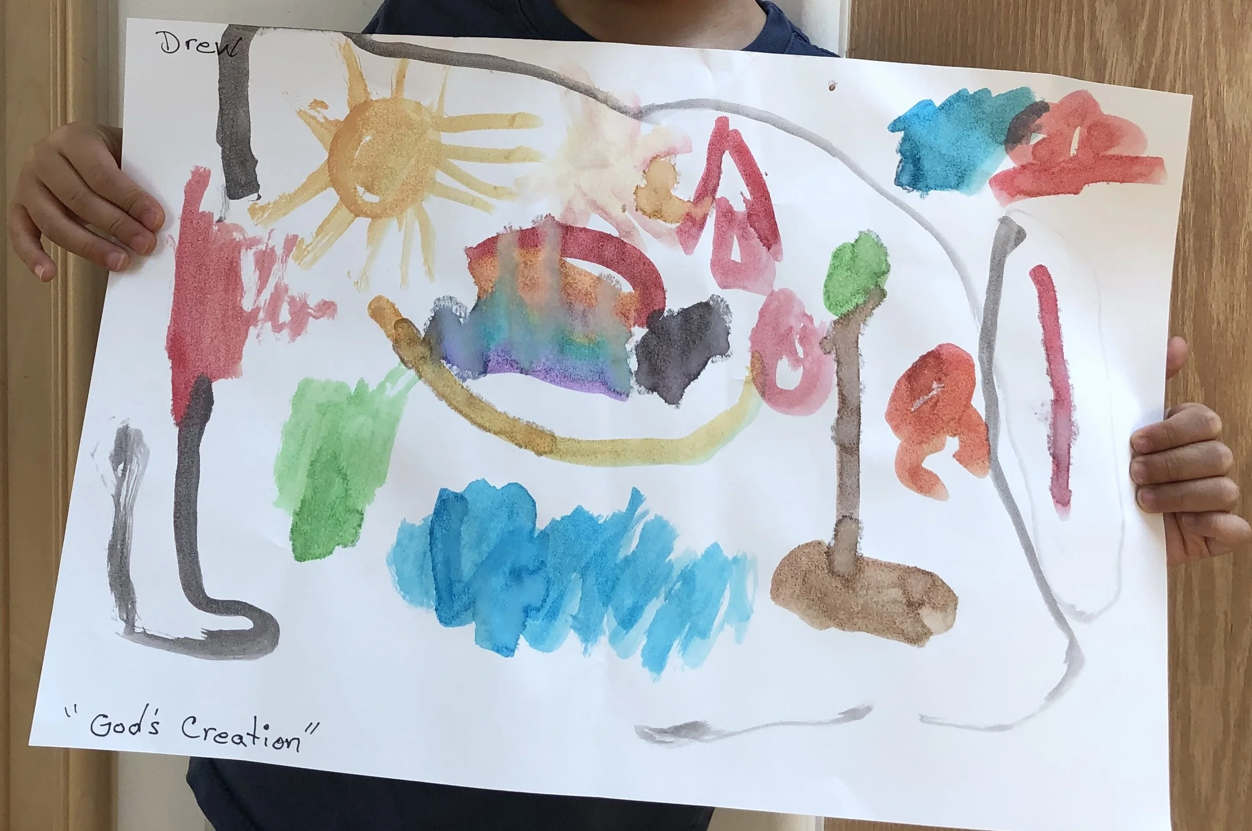 My 4-year-old son’s painting of “God’s Creation.” The red shapes on the left side and top right corner are fires in the mountains and the black strokes across the sides and top are smoke.