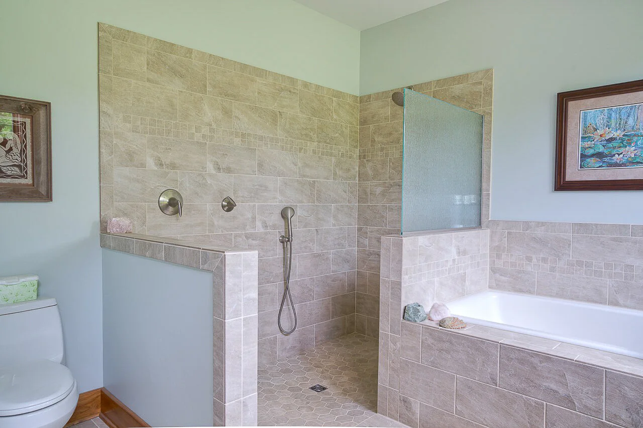 The deep soaking tub and shower share a similar view