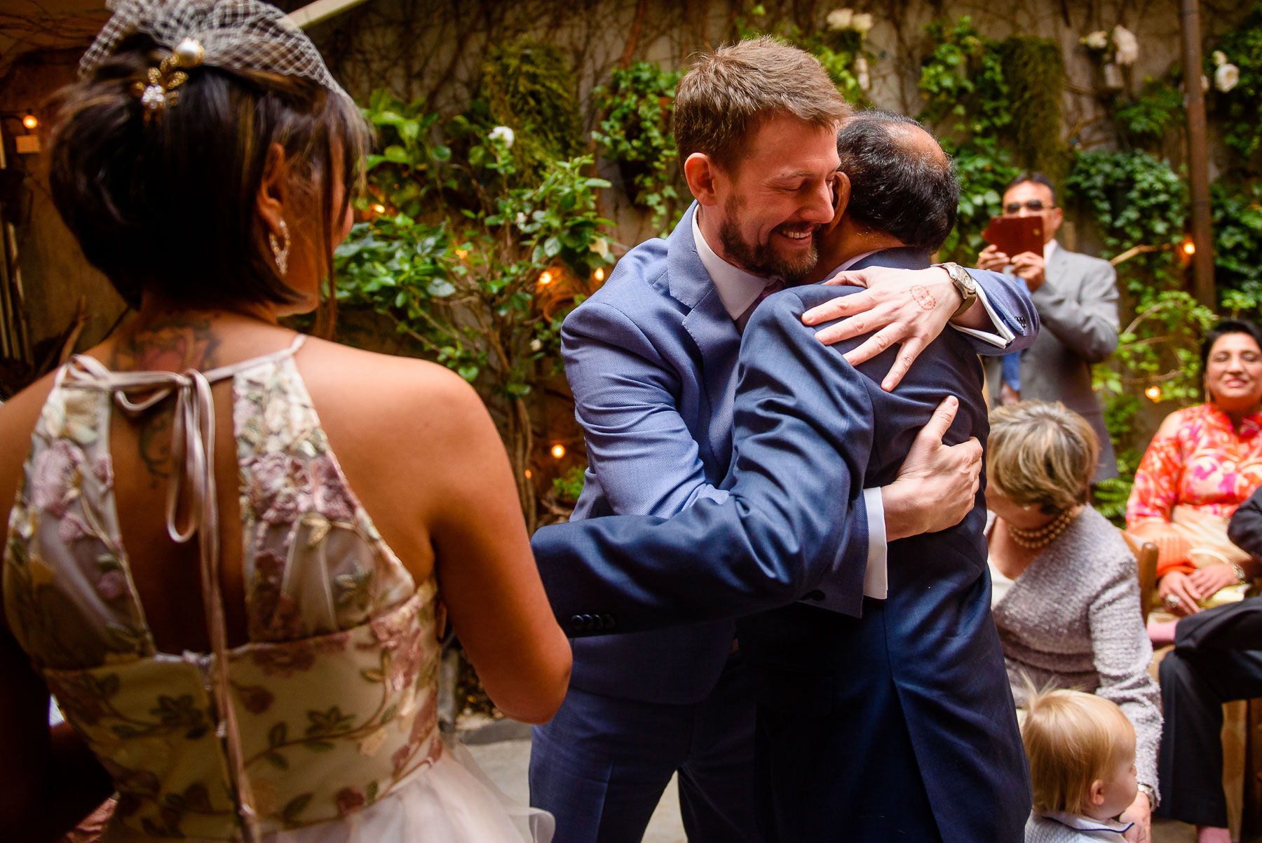 Palma Restaurant Wedding groom hugs father-in-law