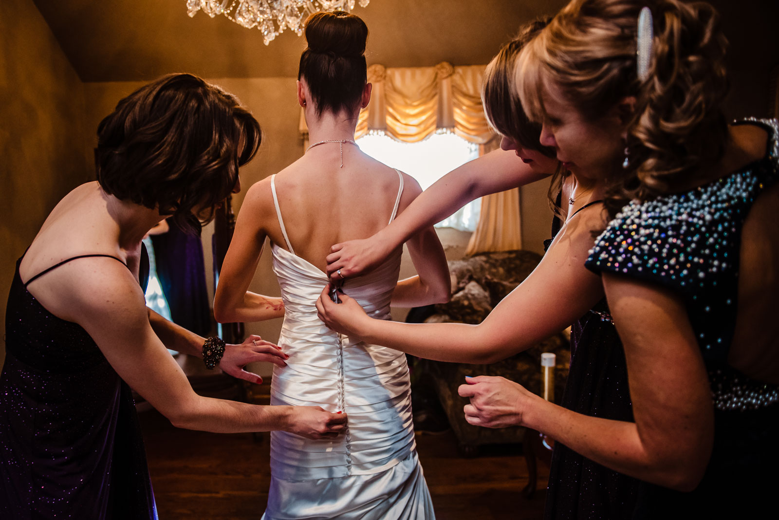 Bride puts on her dress