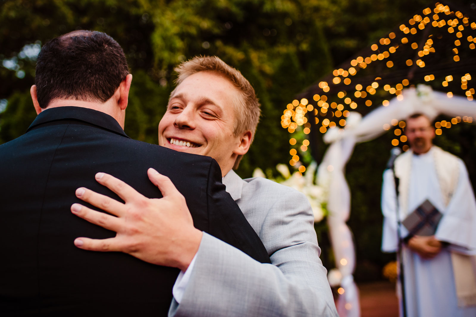 Groom hugs father in law