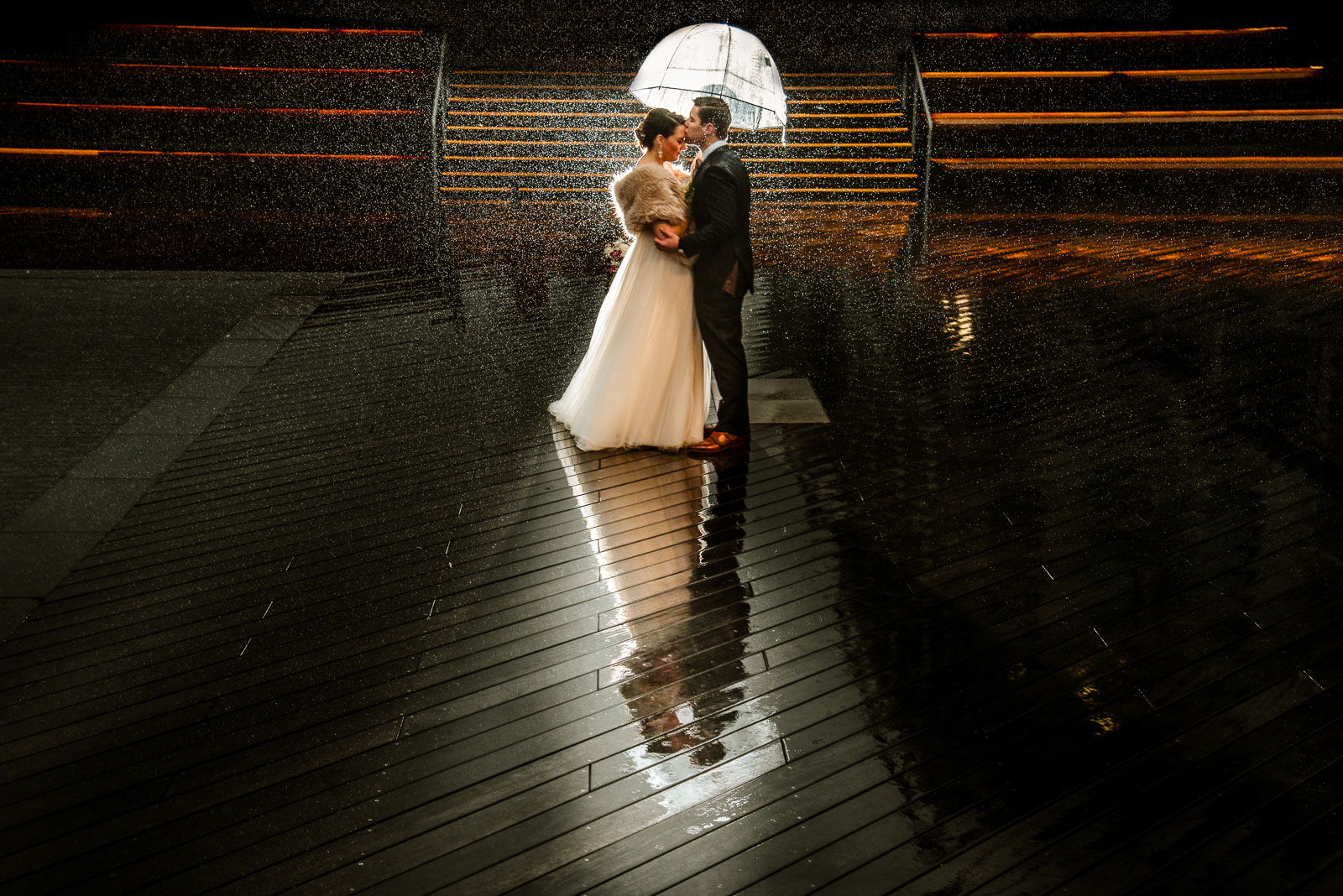 Bride and groom portrait in the rain
