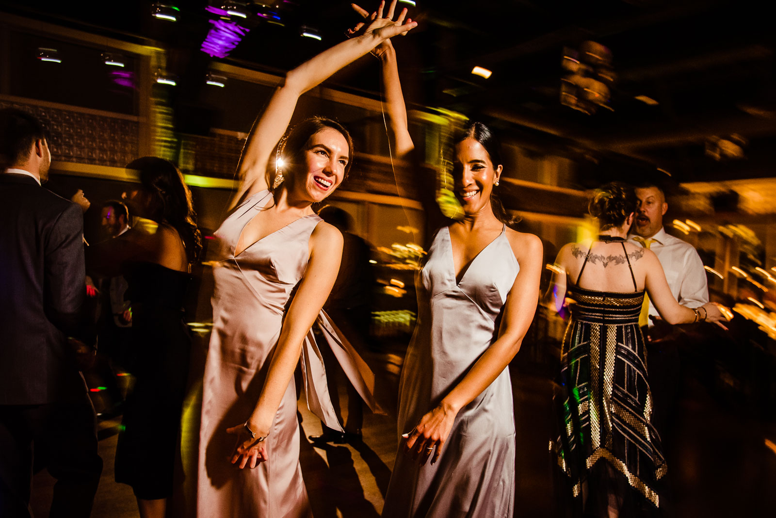 Two bridesmaids dance