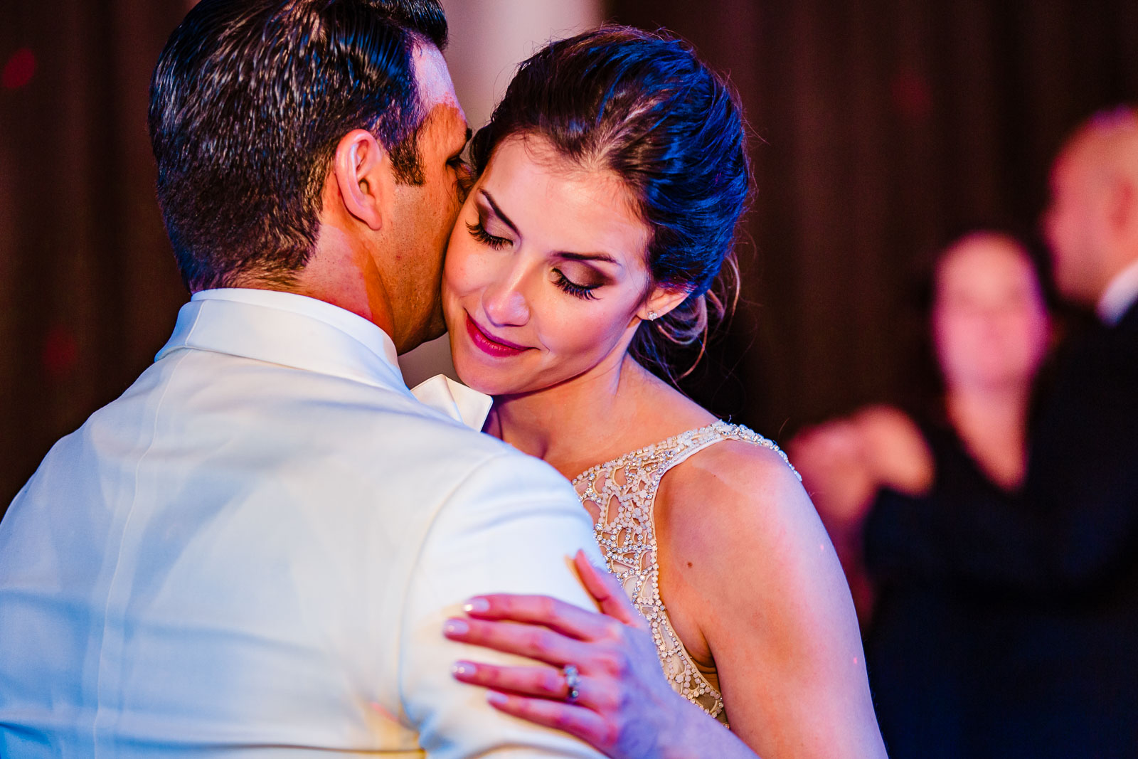 Groom kisses bride during first dance