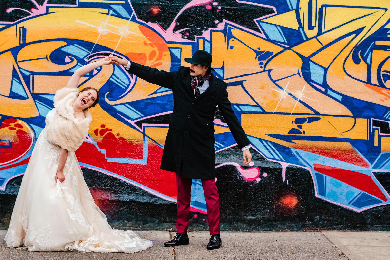 Bride and groom dance on a street