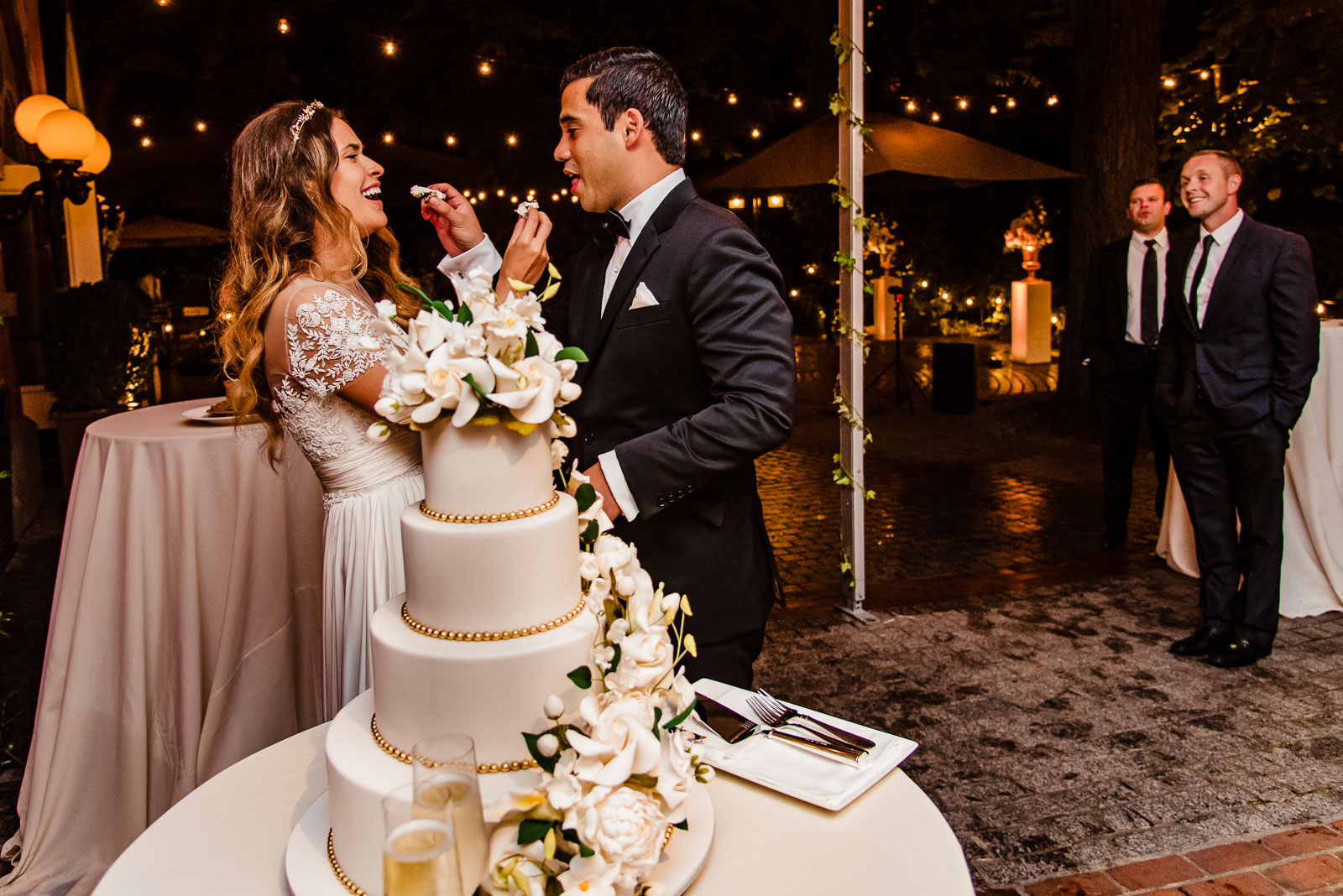 Bride and groom feed each other cake