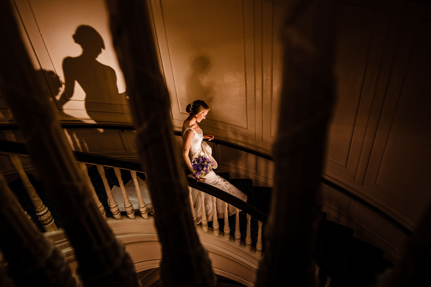 Bride walks down the spiral staircase