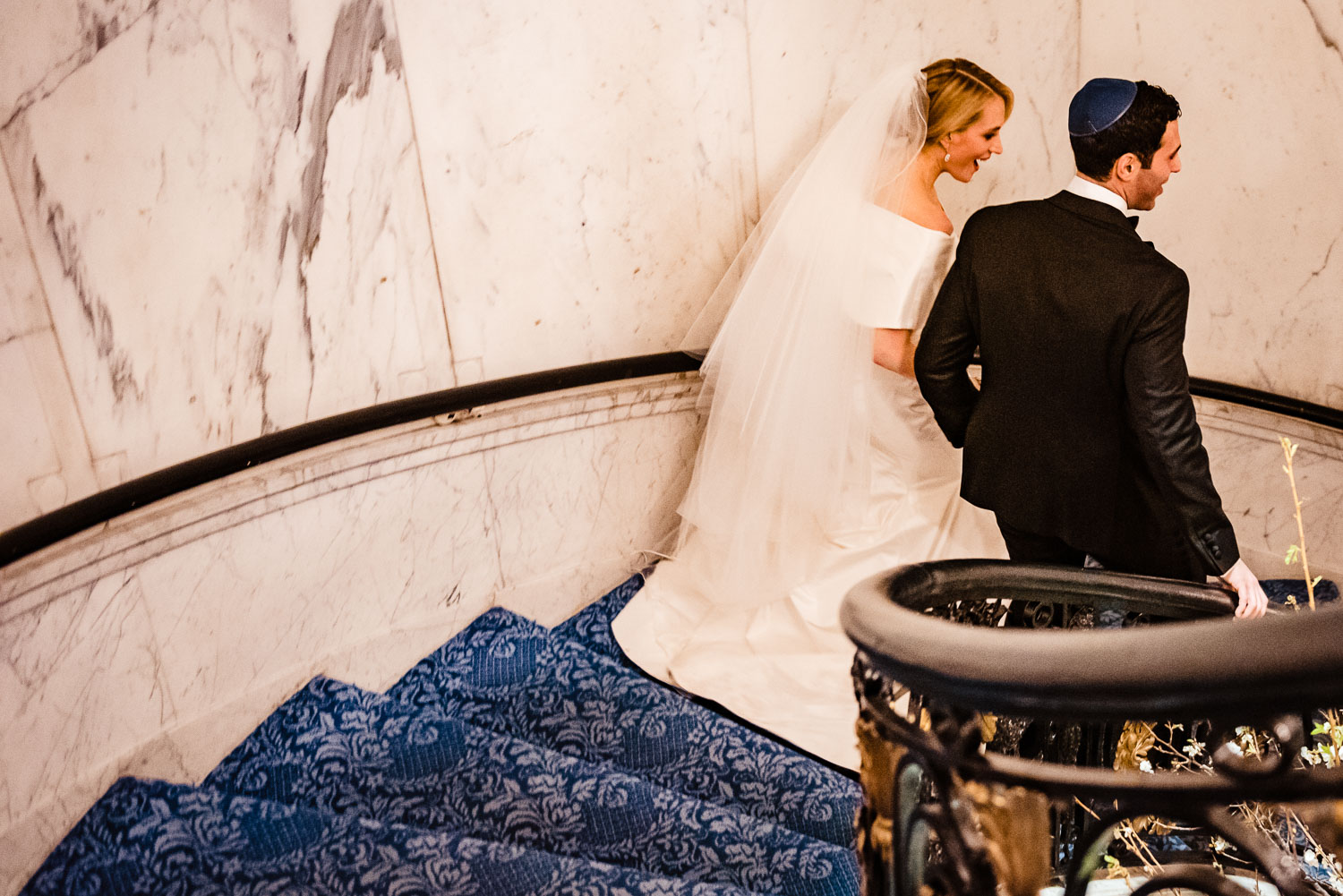 Bride and groom walk down the stairs togather