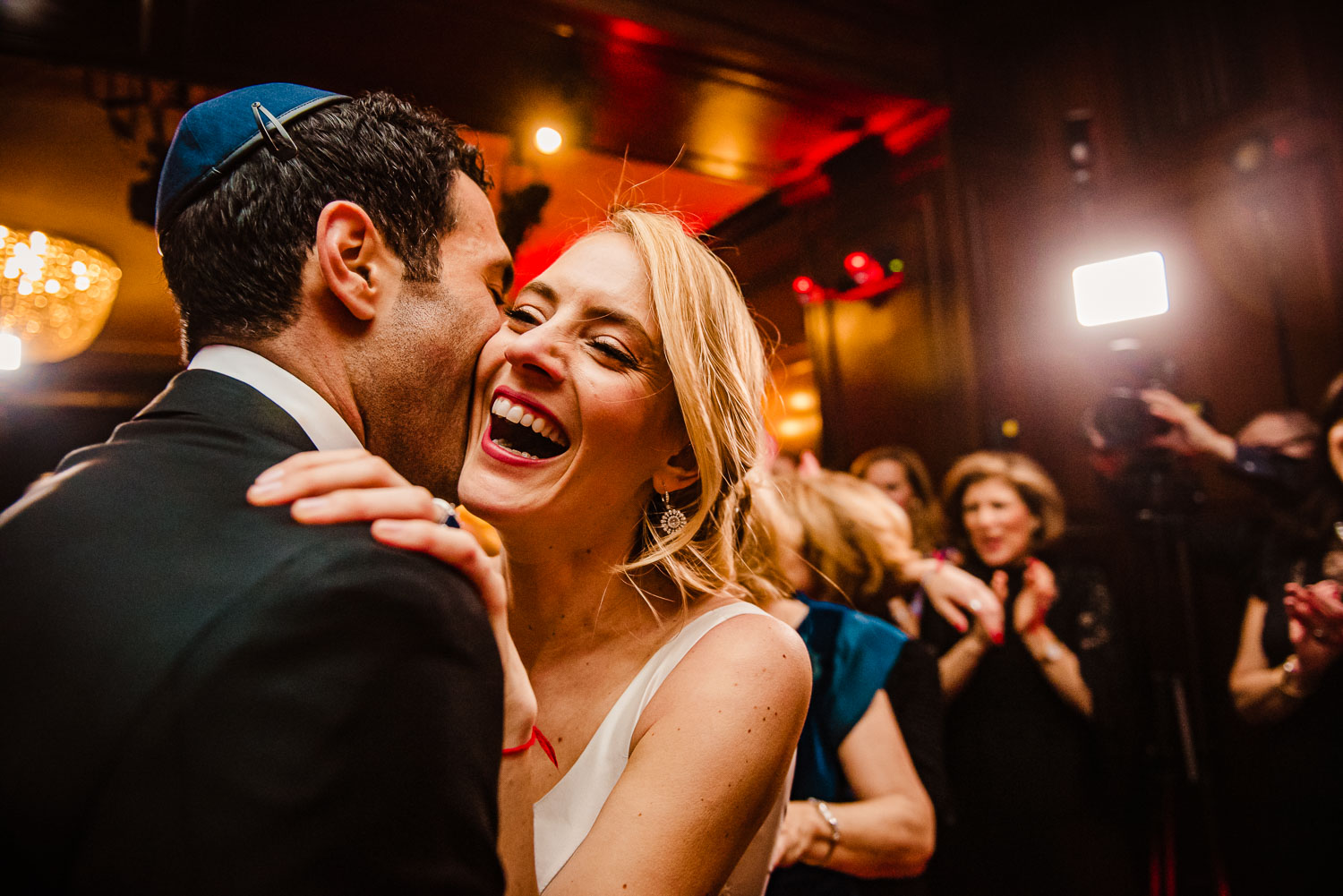 Bride and groom kiss on the dance floor