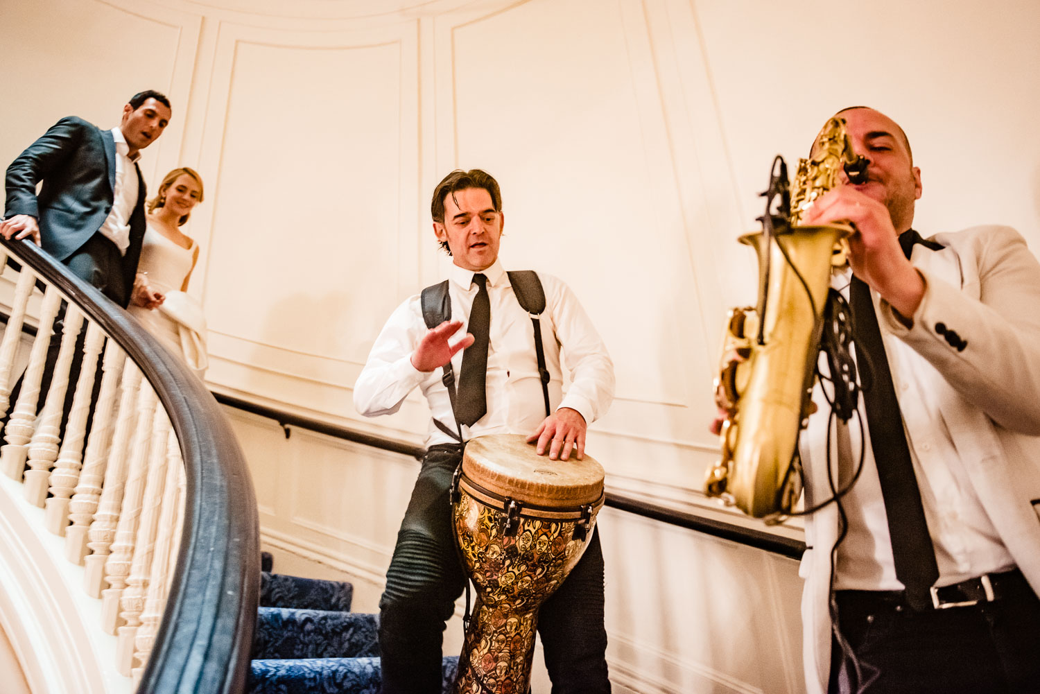 Newlyweds led by musicians to the reception