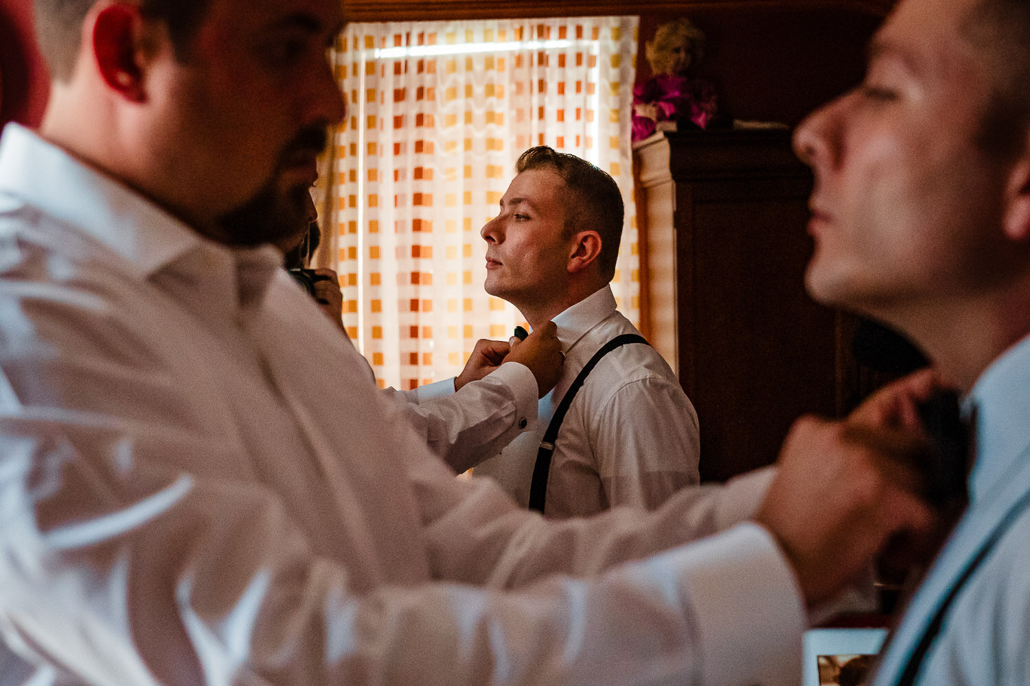 Groom gets ready for the wedding in his home