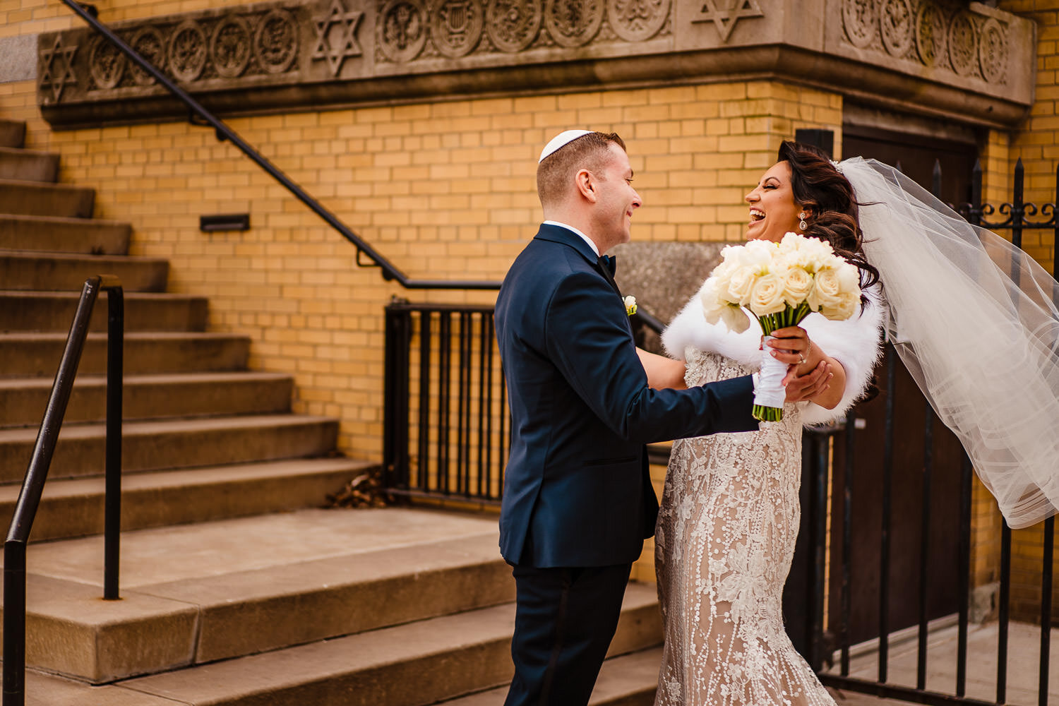 Bride and groom react after first look in front of Park Slope Jewish center