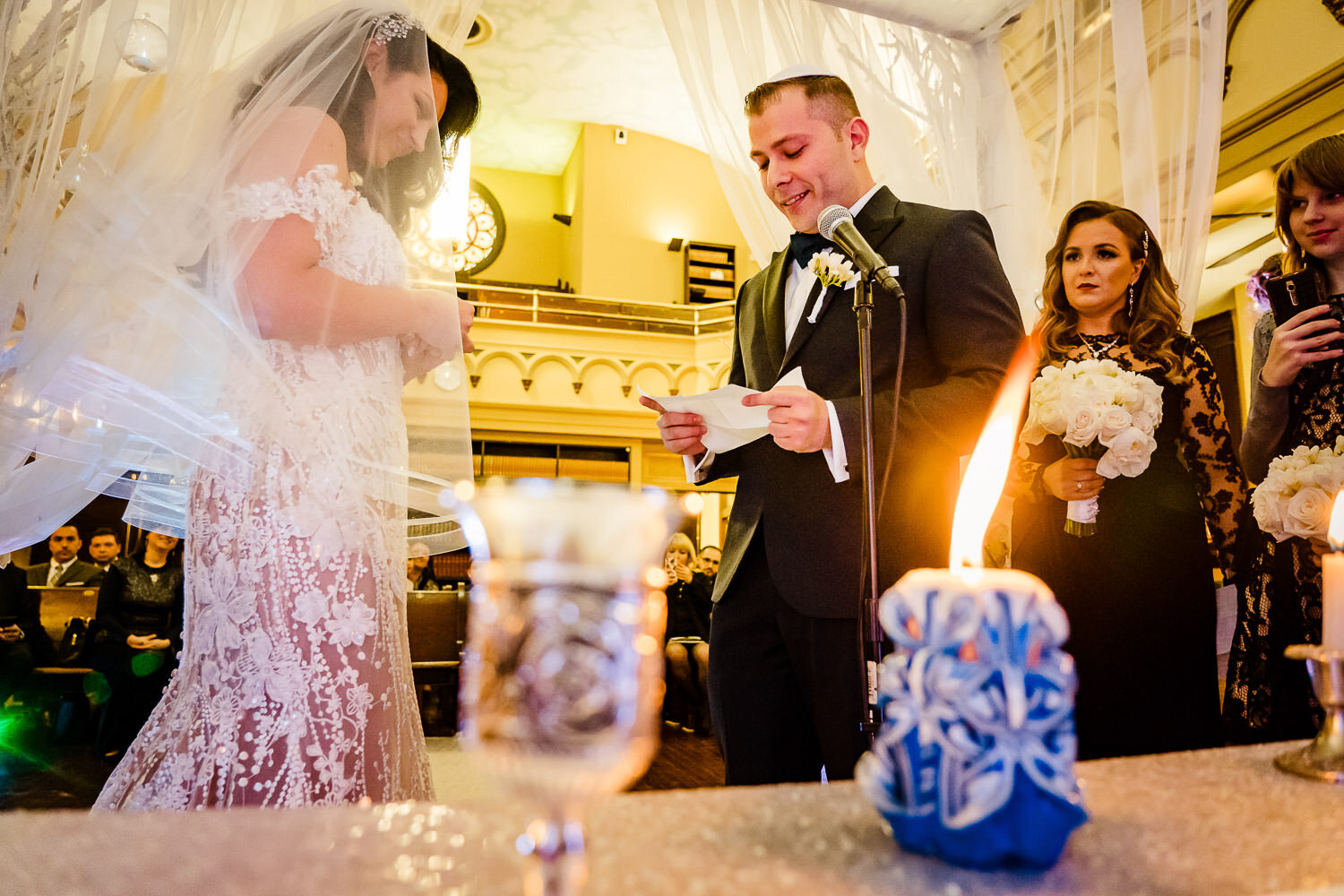 Groom reads his vows during ceremony at Park Slope Jewish center