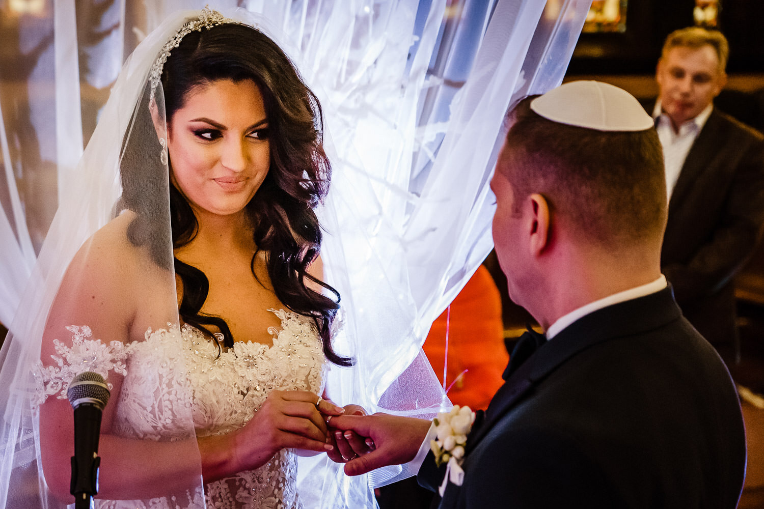 Bride and Groom exchange rings during ceremony at Park Slope Jewish center
