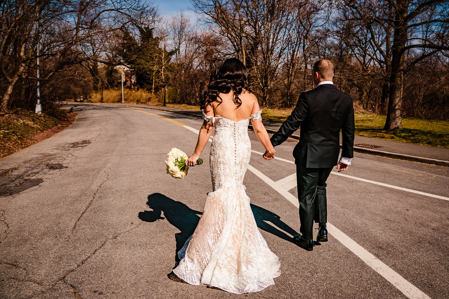 Bride and groom walk togher at Prospect Park