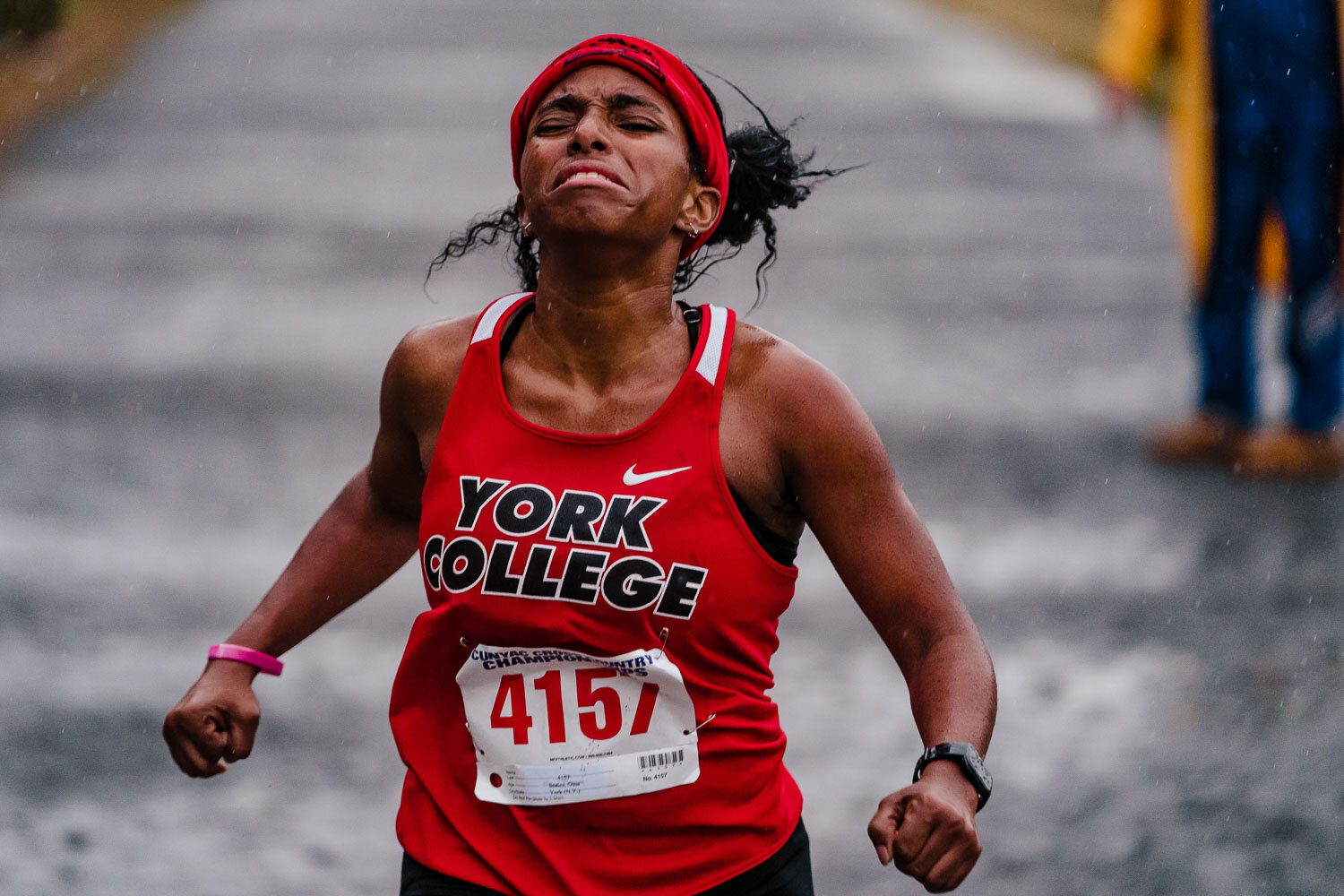 York College runner crosses finish line during CUNYAC Championship race at van cortlandt park