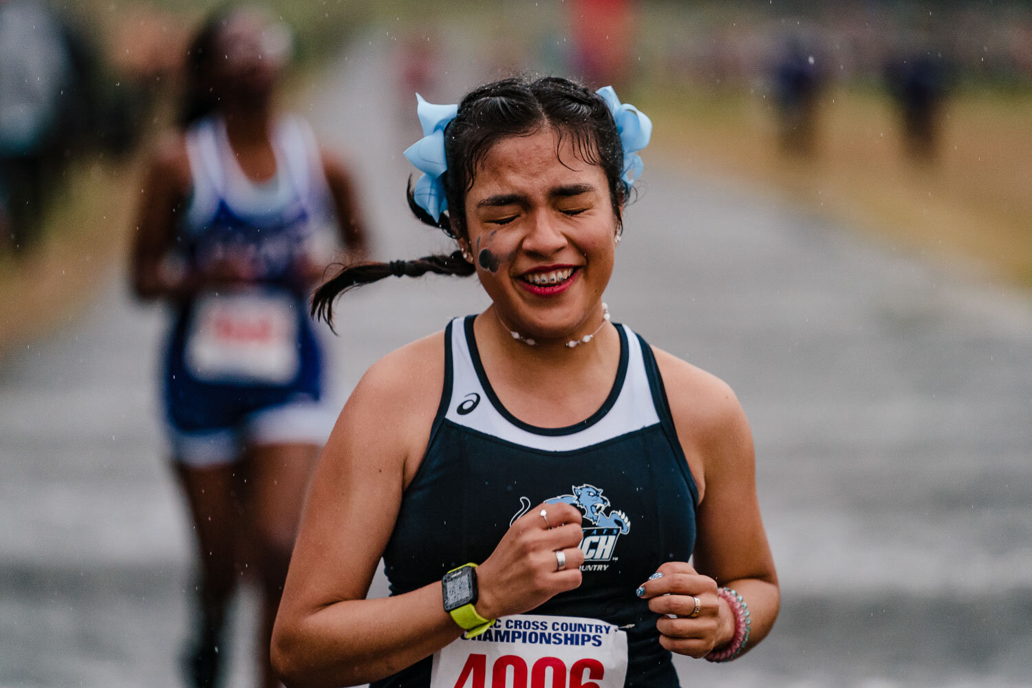 Baruch college runner crosses finish line during CUNYAC Championship race at van cortlandt park