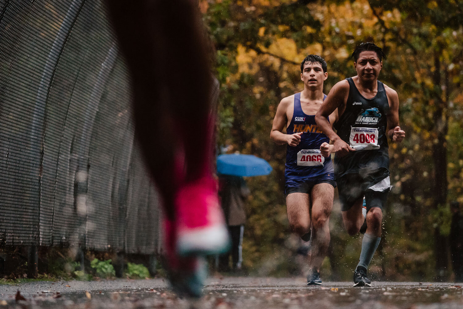 John Jay and Hunter runner in the rain during CUNYAC Championship race at van cortlandt park