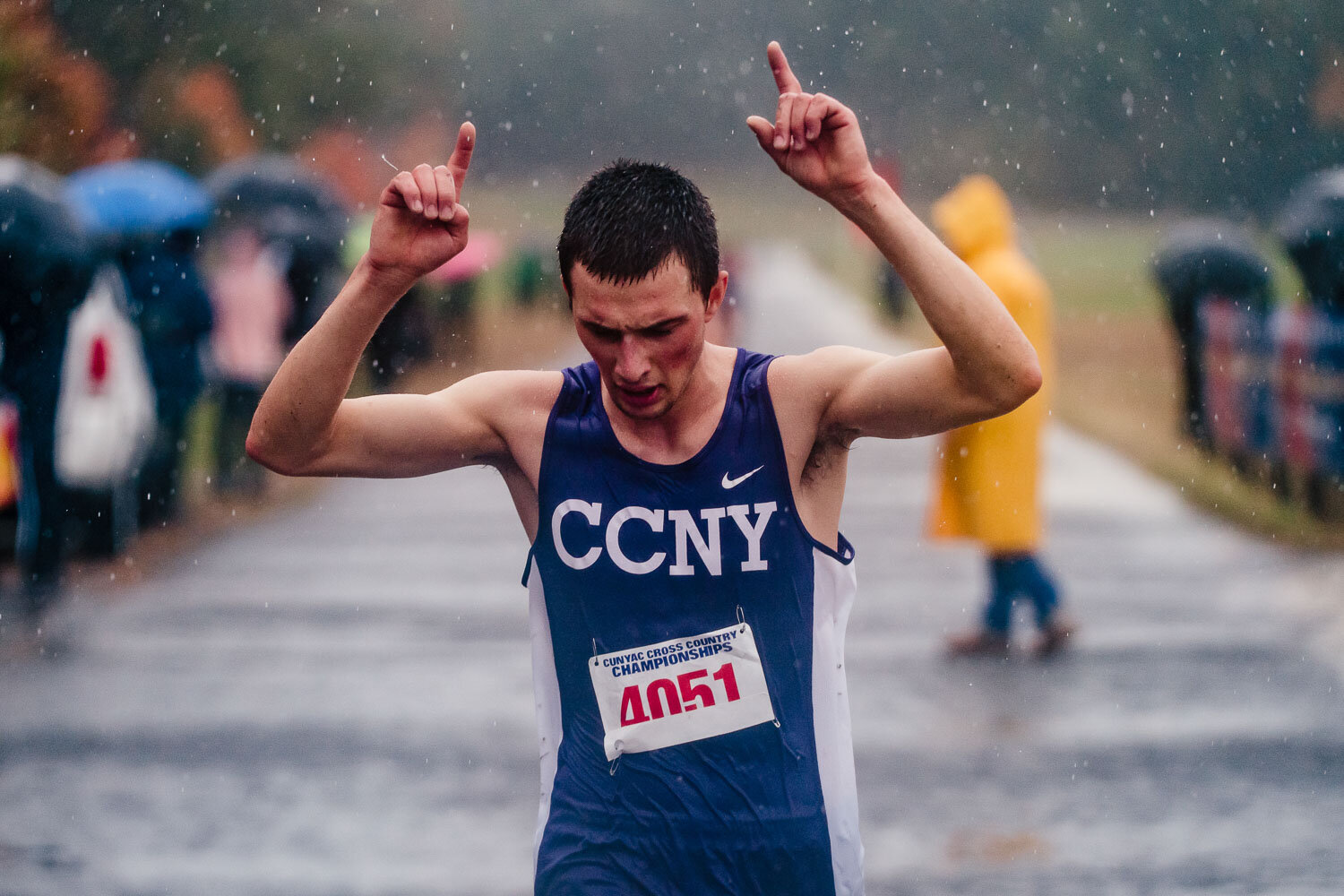 CCNY runner croses the finish line during CUNYAC Championship race at van cortlandt park