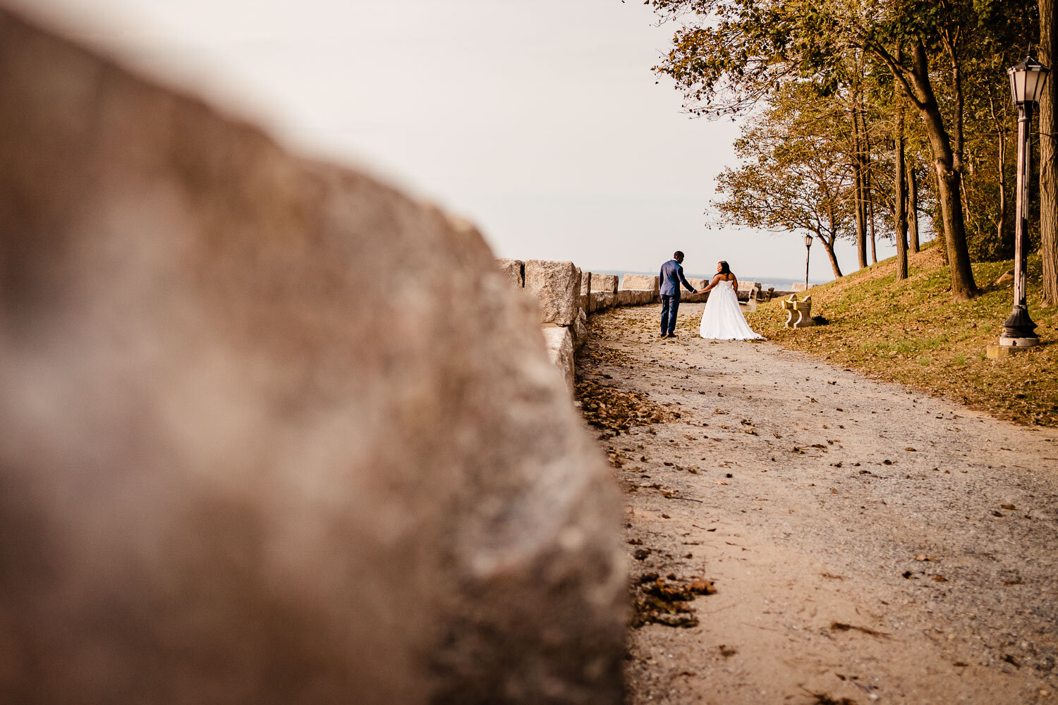 Bride and groom walk togather in Morgan Memorial Park in Glen Cove 