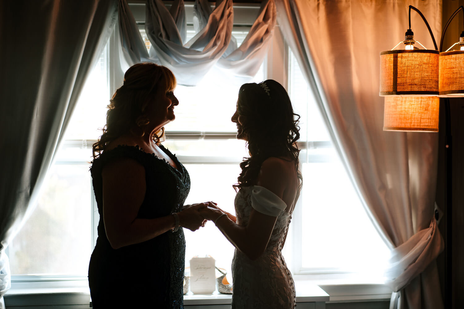 Bride and her mother enjoy the momemnt during preparations