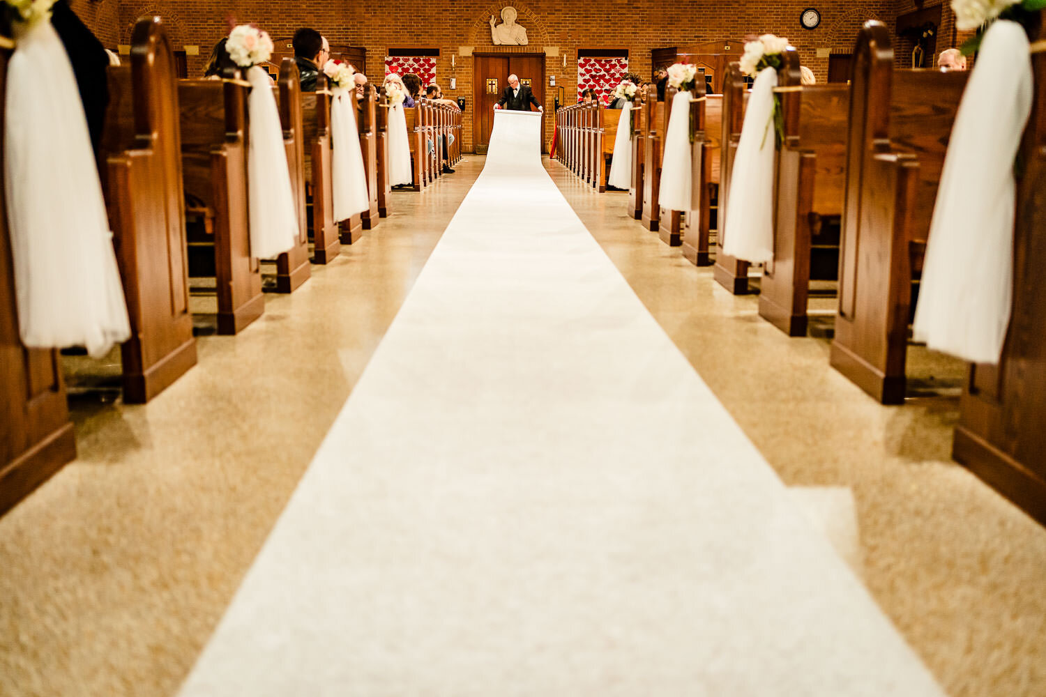 Aisle Runners is set up before the ceremony at St. Margaret Cath
