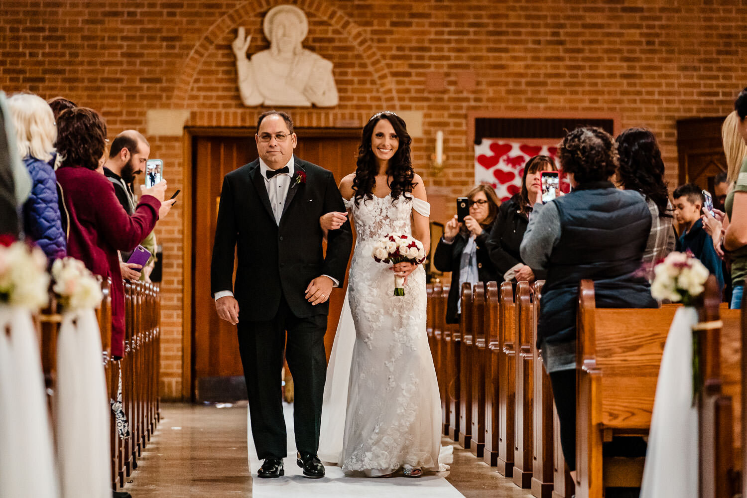 Dad leads his daughter to the ceremony at St. Margaret Catholic 