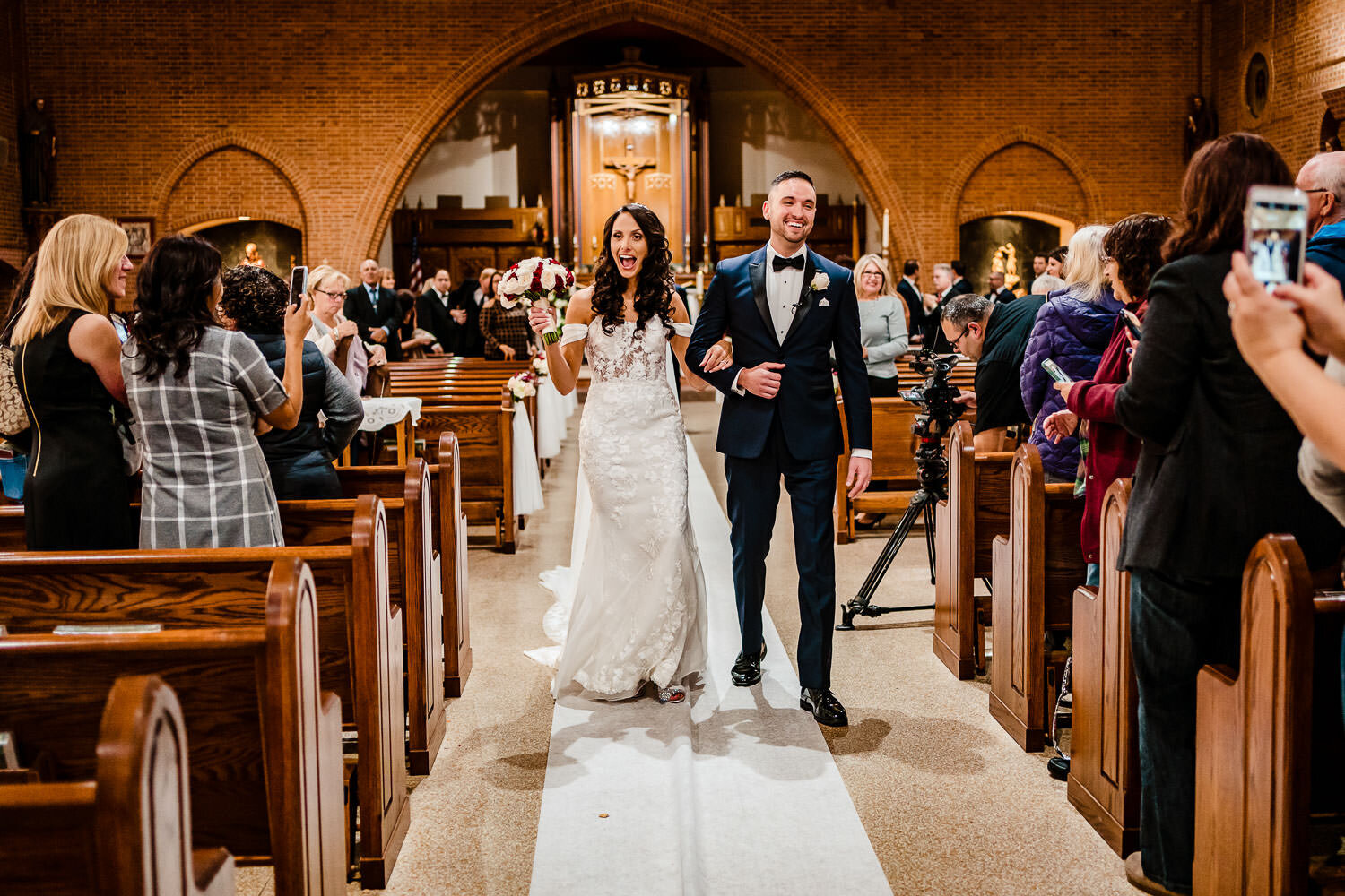 Bride and groom exit after the ceremony at St. Margaret Catholic