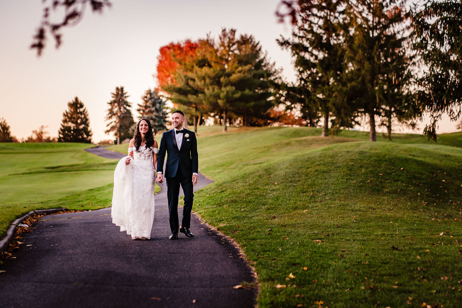 Newlyweds walk on the golf course path at Royalton on the Greens in Melville on Long Island