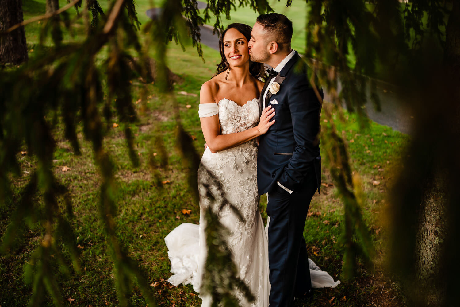 Bride and groom portrait through the trees at Royalton on the Gr