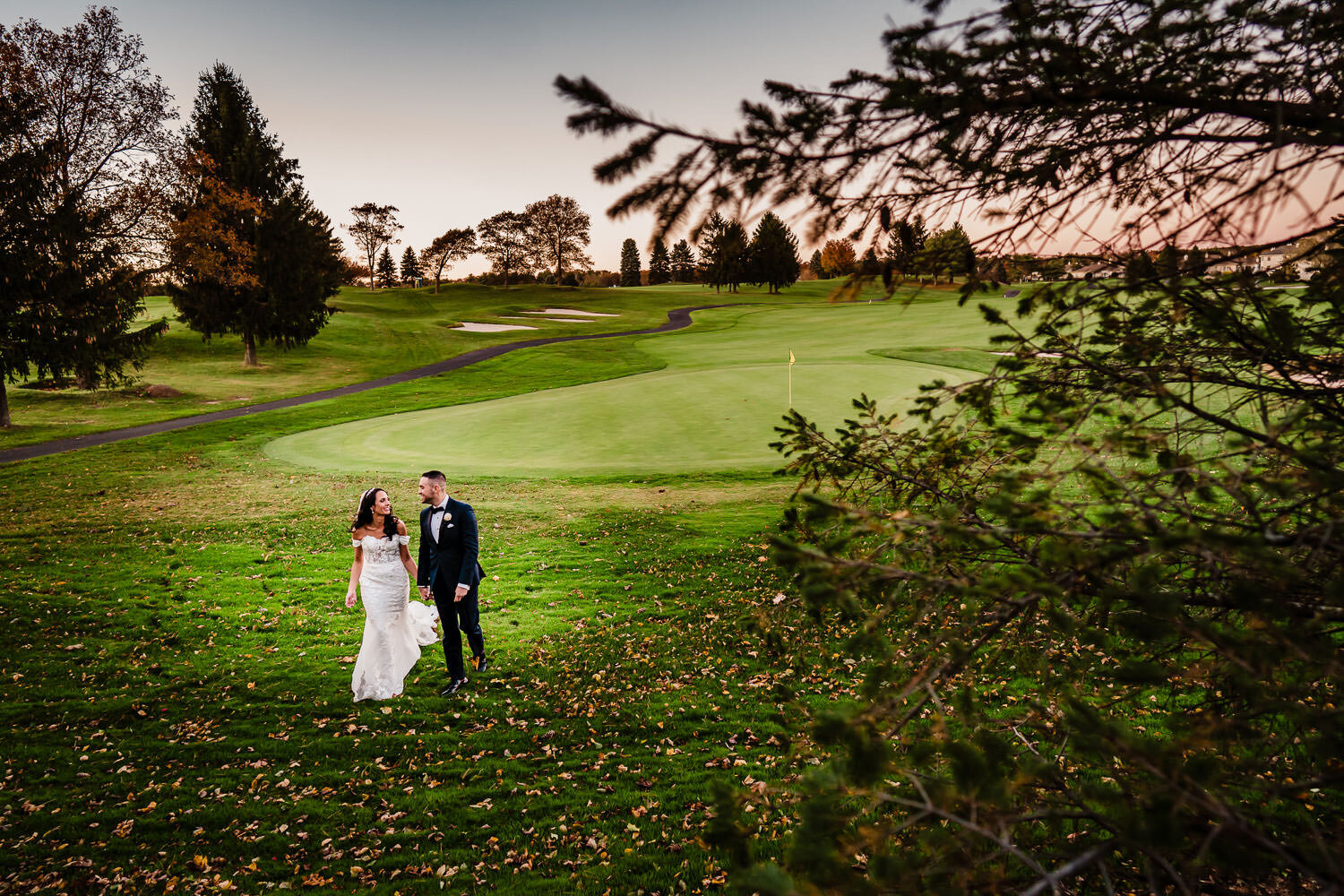 Newlyweds stroll on the golf course at Royalton on the Greens in Melville on Long Island