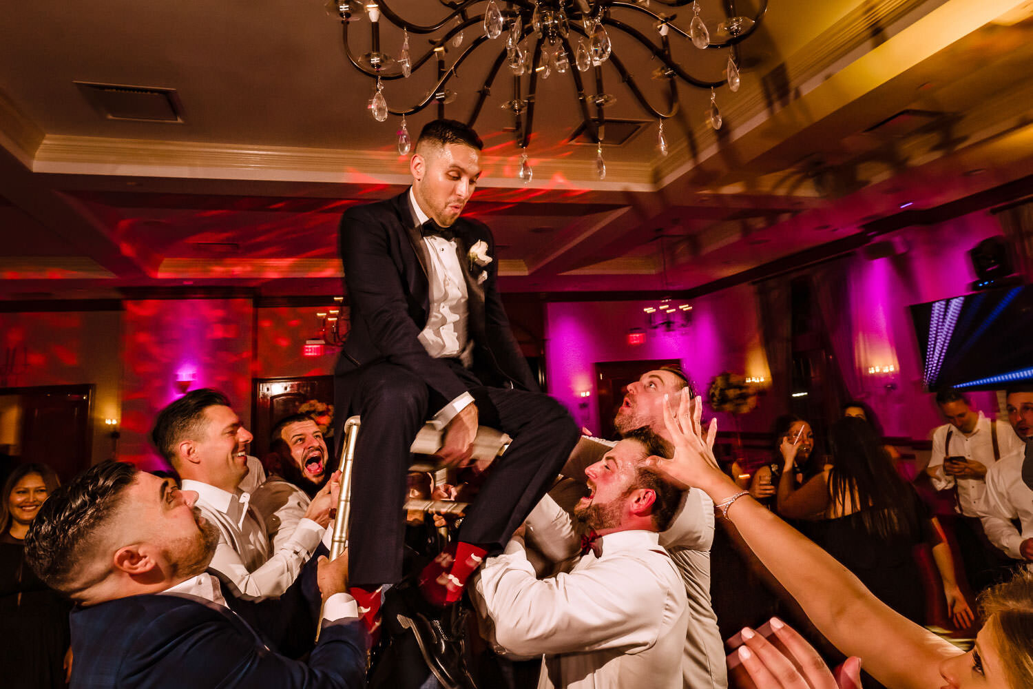 Groom raised on a chair at Royalton on the Greens in Melville on