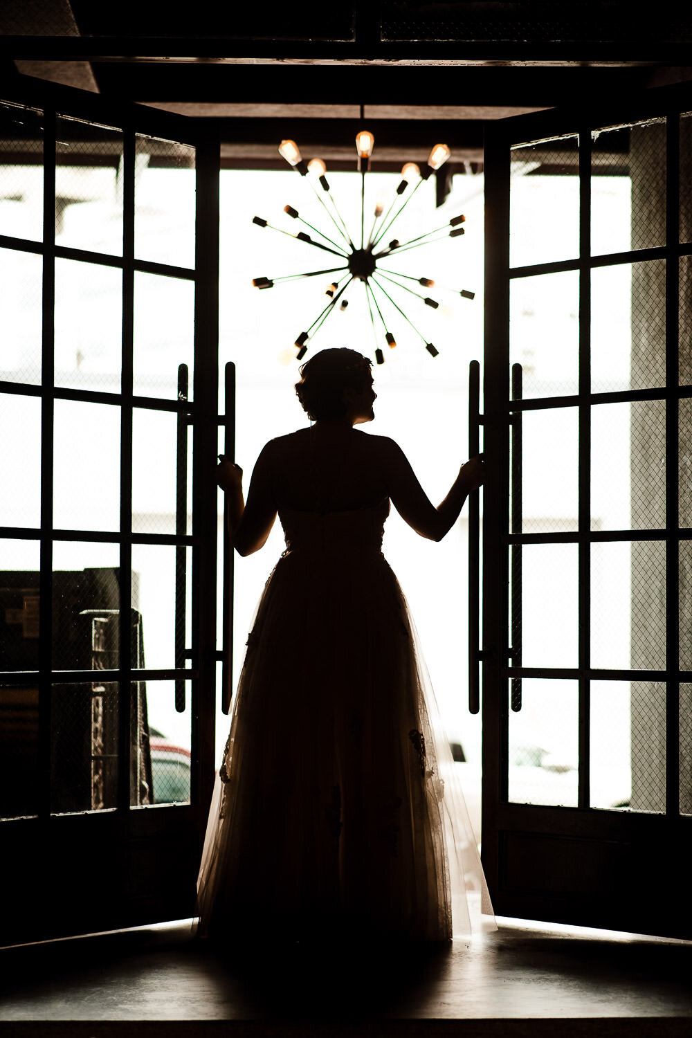 Bride's portrait by front doors at Paper Factory Hotel in Long Island City