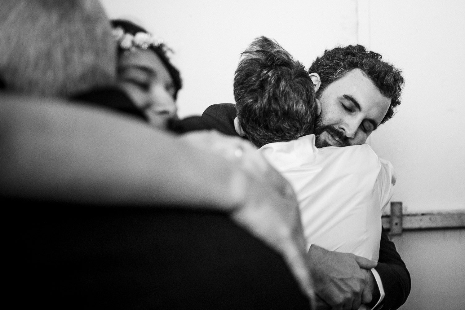 Bride and groom hug and greet guests during reaction at Aurora Gallery in Long Island City