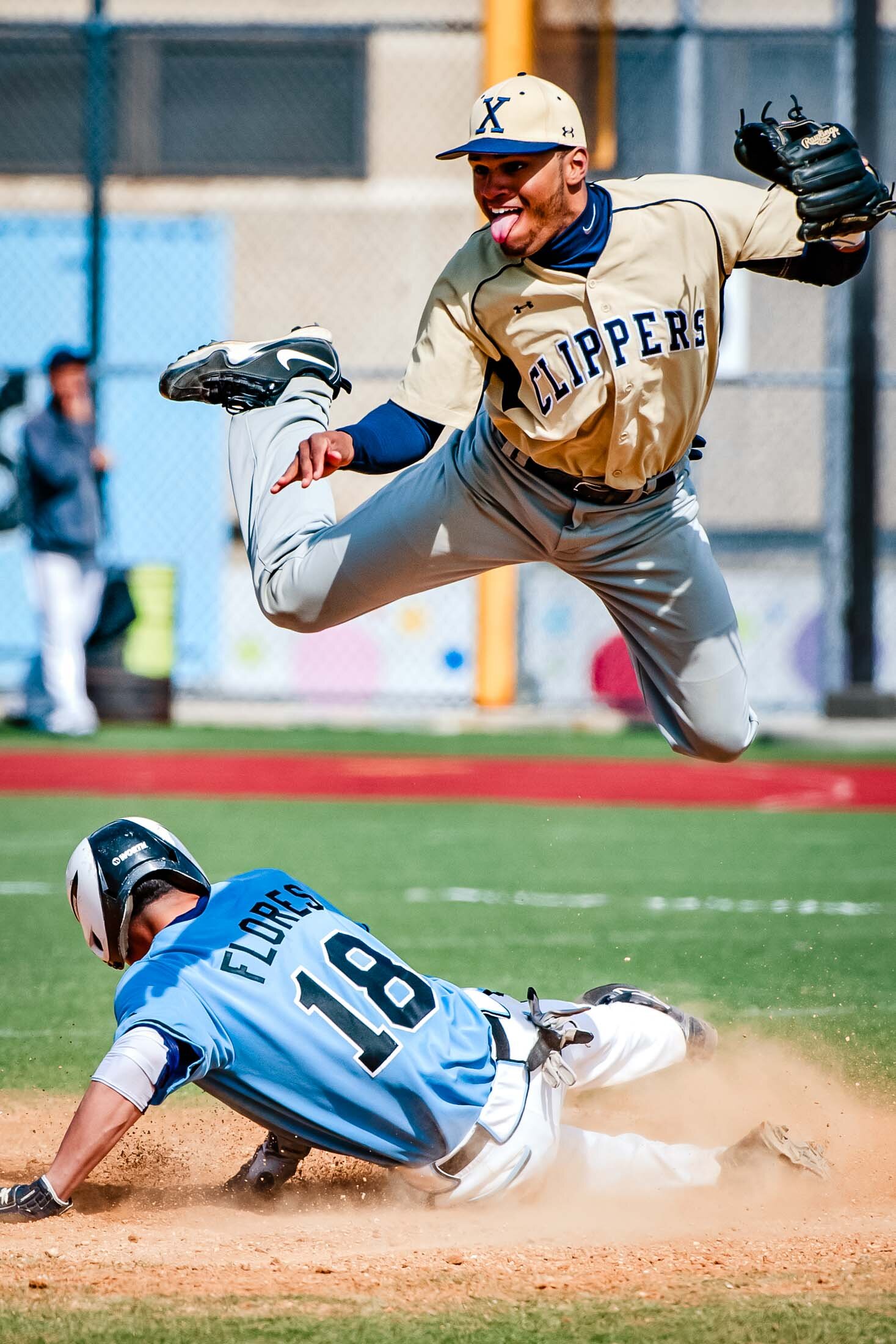  Xaverian's Gabe Hernandez jumps over Grand Street's Kelvin Flores on second base in Grand Street HS in Brooklyn 