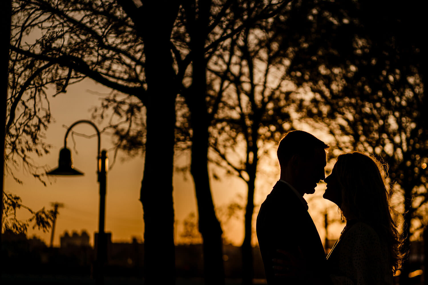 Couple's silhouette portrait at sunset at Hoboken train station