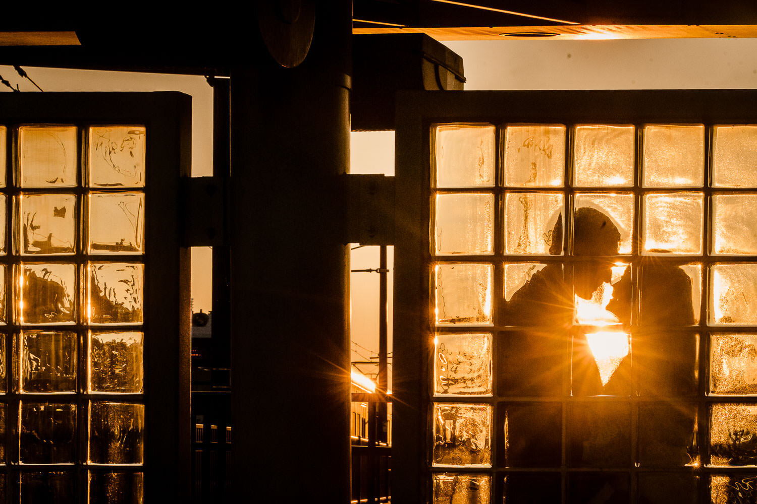 Couple's silhouette portrait at sunset at Hoboken train station