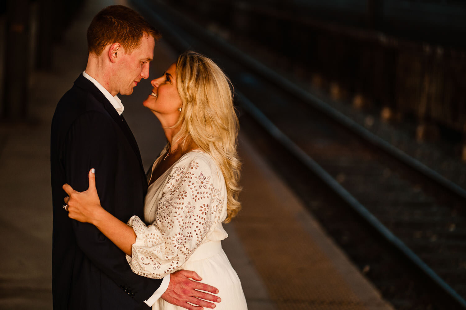 Couple's portrait near the tracks of Hoboken train station