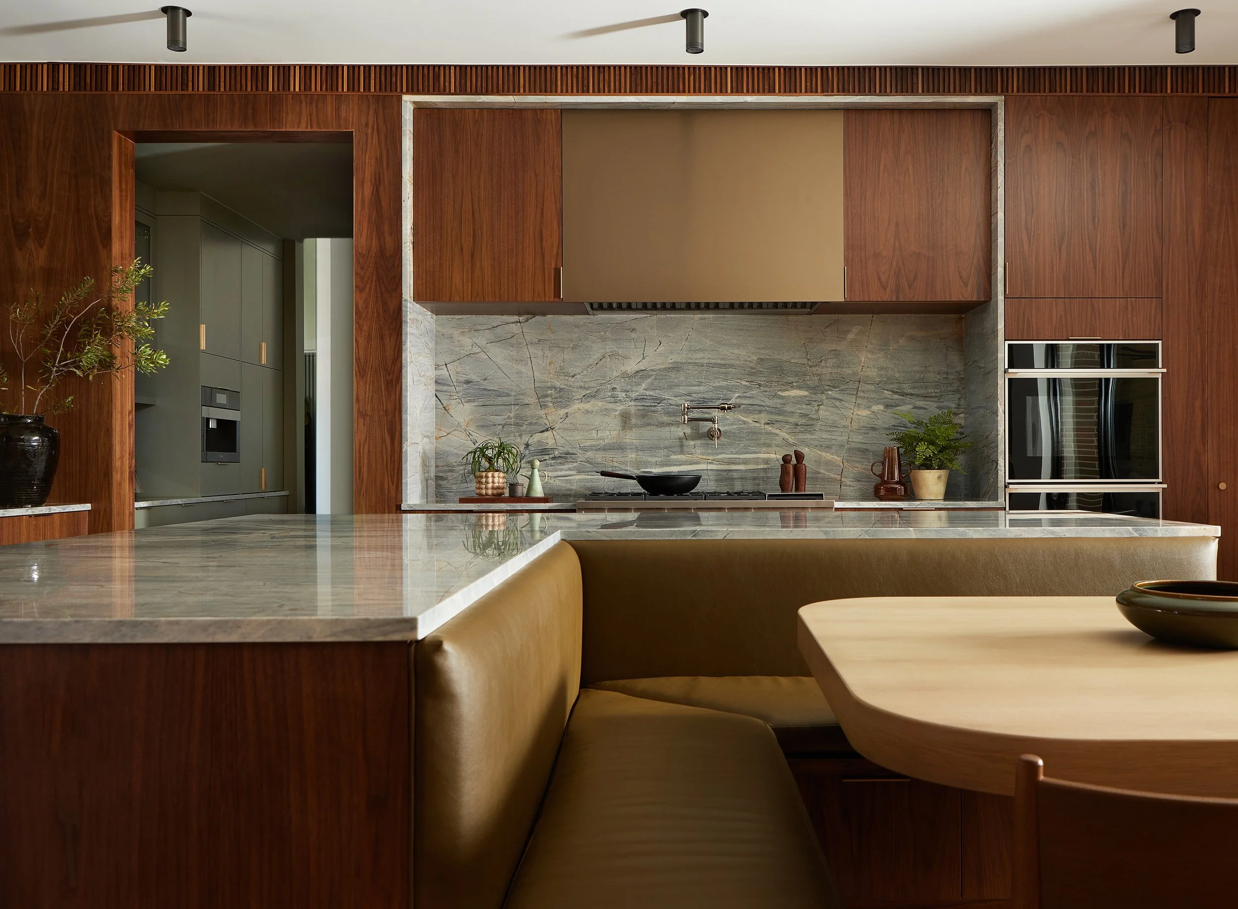 Modern kitchen with dark walnut cabinets and marble photographed by Matti Gresham