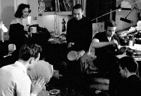  a young Gunn (middle) plays the bongos next to James Dean (right of Gunn) at a party with other actors 