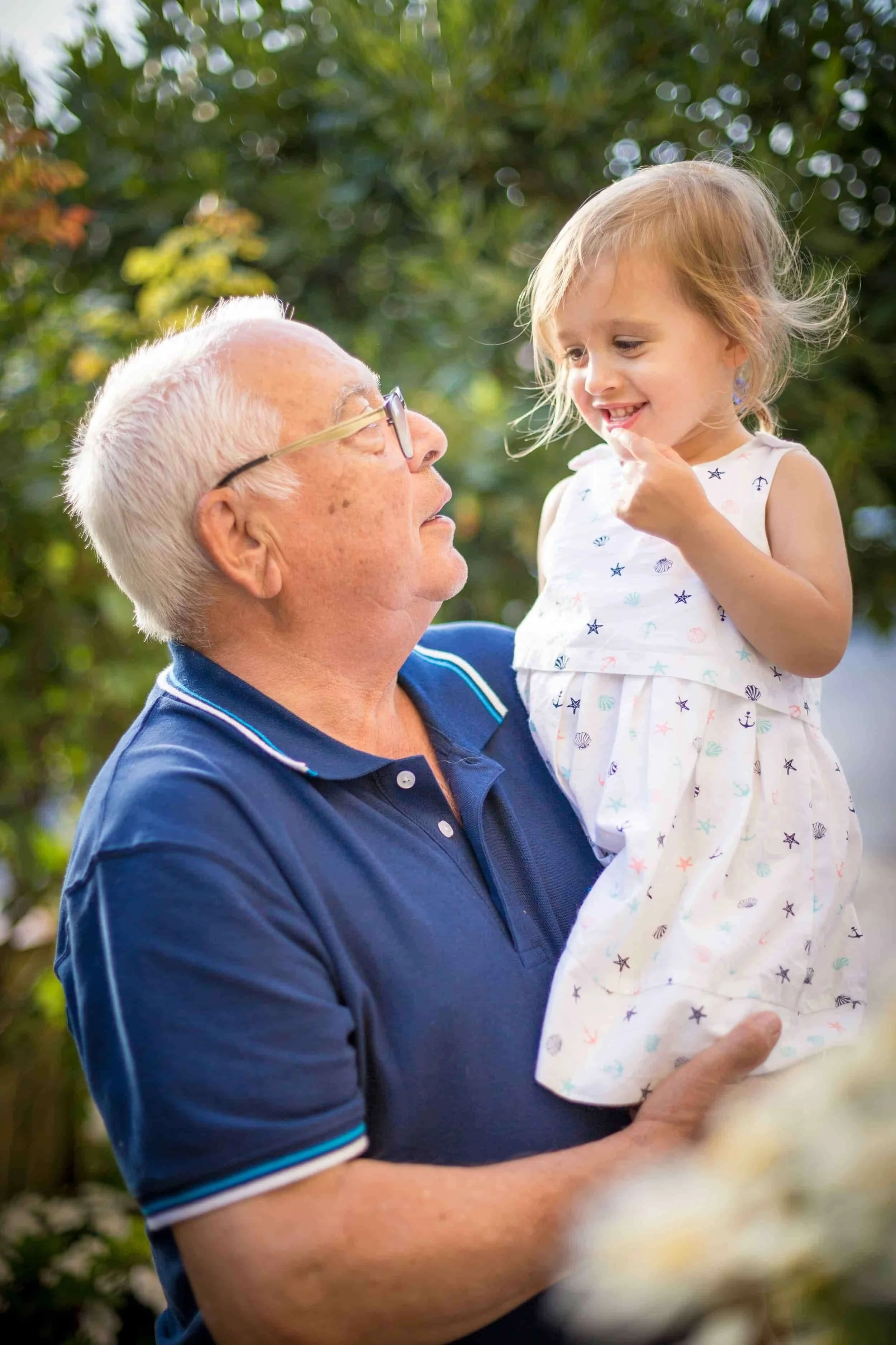 grandpa holding granddaughter