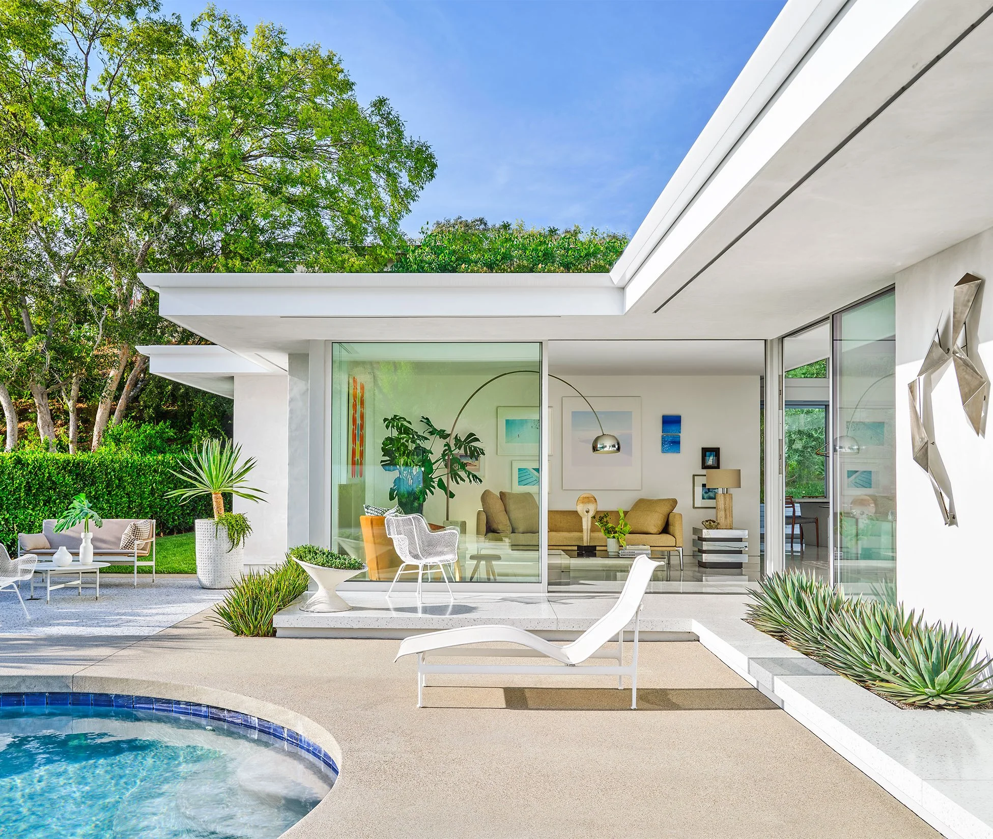 iconic mid century modern foyer design in Beverly hills luxury residential by Luis fernandez Milo Baughman Willy Rizzo Curtis Jeré terrazzo flooring olive tree framing nature picture window modernist design