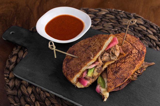 Spice up your Friday with our Torta Pambazo: citrus pork carnita, guajillo sauce, chipotle, avocado, pinto beans, chorizo sausage, pickled onions and tomato salsa on Mexican-style bread 💃🏽