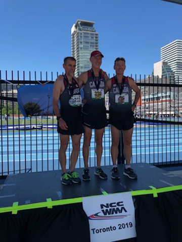 Mark Pinckard (Centre) receives his Gold Medal for the 1500m