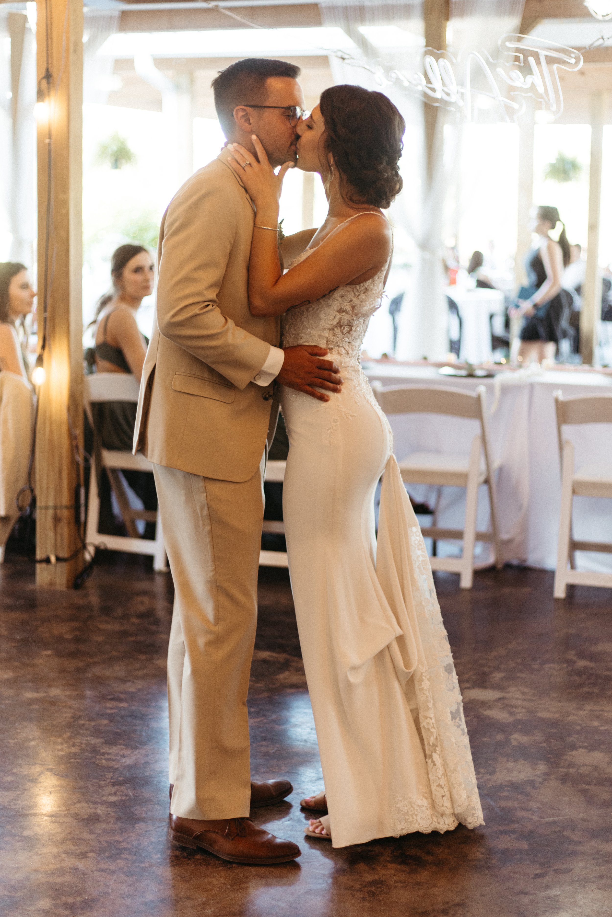 bride and groom kiss after their first dance