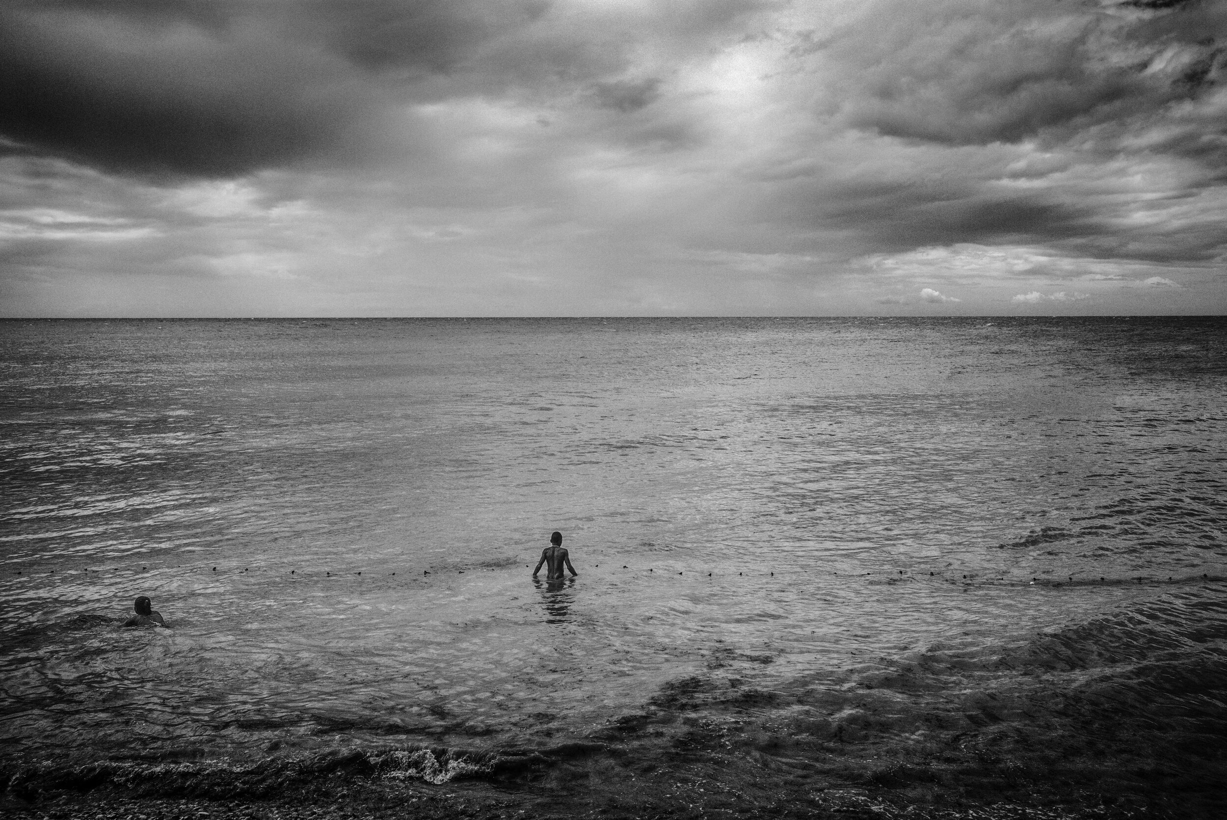  Photo of a man wading into the Caribbean Sea 